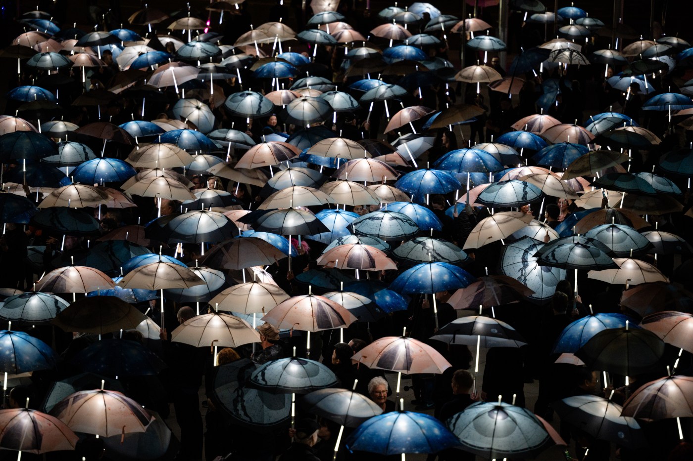 Photos: ‘Invisible Skies’ turns San Jose City Hall plaza into a luminescent art piece with the help of 2,000 participants.